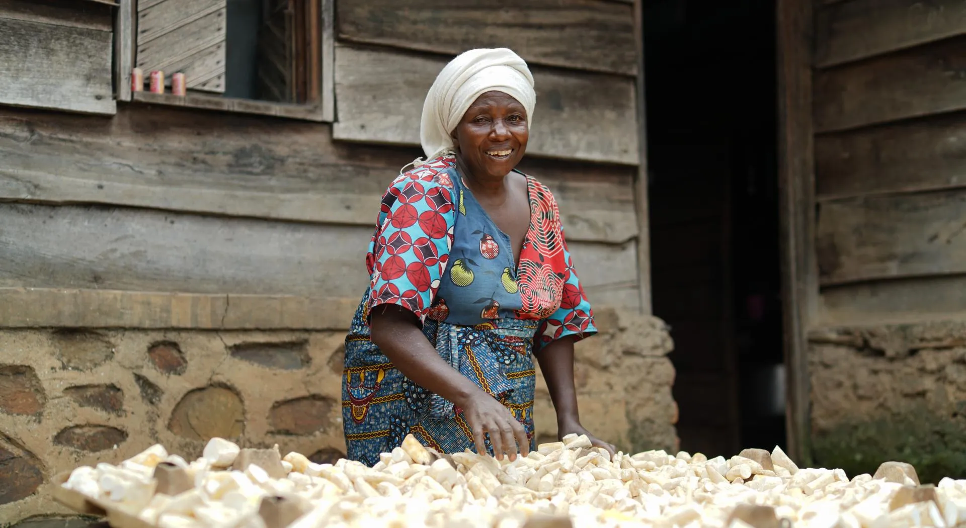 A woman in front of her house in Congo