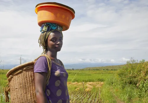 African woman carrying food on her head