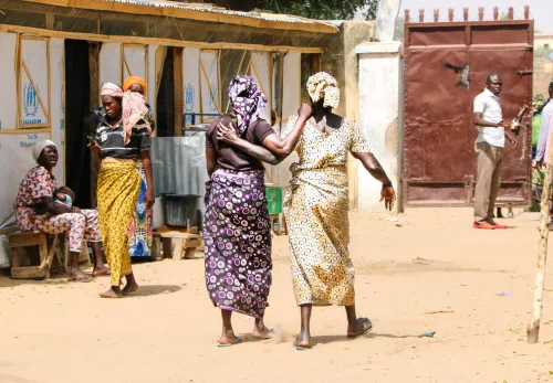 Women walking together and holding each other